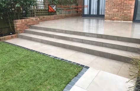 Patio With Steps Down To Garden, Concrete Patio Wood Steps, Porcelain Steps Garden, Wide Patio Steps, Wide Concrete Steps To Patio, Patio Stairs With Landing Concrete, Rounded Concrete Patio Steps, Outside Steps, Sloped Backyard Landscaping