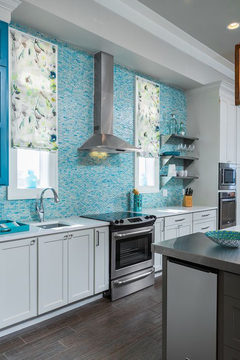 teal-blue-and-white-glass-mosaic-tile-backsplash-covering-the-entire-wall-of-a-kitchen-with-white-cabinets-a-silver-and-black-stove-and-a-metal-extractor-hood Kitchen Backsplash White Cabinets, Backsplash White Cabinets, Kitchen Backsplash White, Colorful Kitchen Backsplash, Kitchen Teal, Malvern House, Blue Backsplash Kitchen, Teal Kitchen Decor, Backsplash White