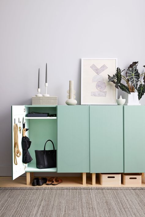 This entryway console is built from two unfinished wood cabinets, which are painted in a soft green. We added wooden legs to elevate the pieces and make room underneath for more storage; you can also mount the cabinets on the wall or stack them.  #marthastewart #organization #declutteringtips #homedecorideas #details Entryway System, Ikea Ivar Cabinet, Mudroom Organization, Elegant Entryway, Ikea Ivar, Entryway Console, Entryway Storage, Entryway Organization, 아파트 인테리어