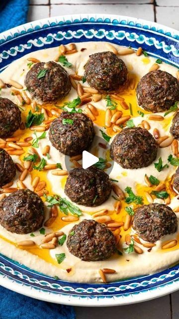 Suzy- Mediterranean Food & Diet on Instagram: "Meatballs & Hummus 😋Recipe👇  Have you ever thought of trying baked meatballs over hummus?   Most people think spaghetti and meatballs, but if you’re up for something new and best level delicious, MAKE THIS easy dinner!   You’ll love the Middle Eastern seasoning in these meatballs! it’s basically what I use for my kofteh kebabs-allspice, cardamom, paprika, sumac, onions, garlic, parsley! Yes, these kofta meatballs are a flavor party!!🎊   Serve them over creamy dreamy hummus with a drizzle of good olive oil and some pita bread and watch how quickly people eat it!   Sure, this can make the perfect mezzo or appetizer, but in my house, this is the perfect protein packed meal / dinner! No one is ever mad when I make this easy Lebanese style recip Lebanese Party Food, Lebanese Appetizers Parties, Middle East Meatballs, Lebanese Dinner Party, Middle Eastern Chicken Meatballs, Lebanese Meatballs, Suzy Mediterranean, Middle Eastern Meatballs, Hummus Cup