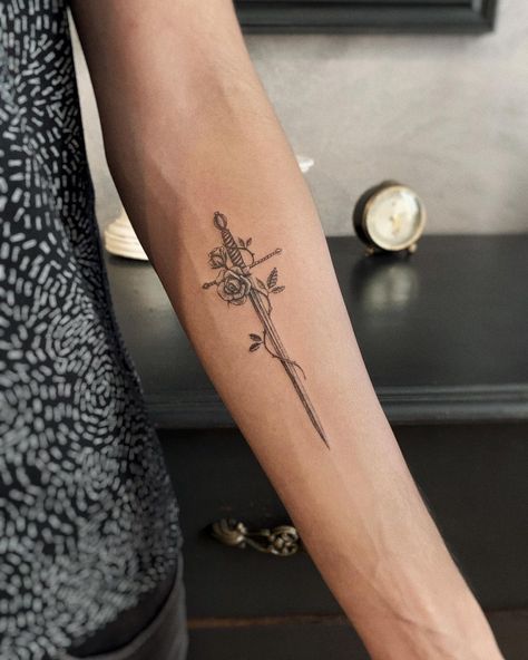 Micro tattoo of a detailed sword with a rose vine. Black and grey, detailed, fineline, microrealism tattoo. Rose Vine Tattoo, Rose And Dagger Tattoo, Rose Vine Tattoos, Dragon Tattoo Ideas, Vine Tattoo, Rose Vine, Vine Tattoos, Greek Tattoos, Stylist Tattoos