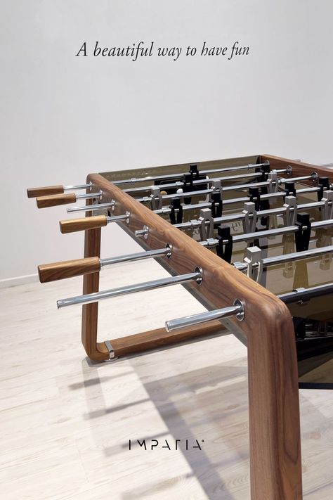 A luxury modern foosball table featuring a stunning walnut wood structure, complemented by a glass playing field. Foosball Table Design, Modern Game Room, Modern Media Cabinets, Modern Game Tables, Small Game Rooms, Foosball Tables, Hangout Room, Foosball Table, Wood Games