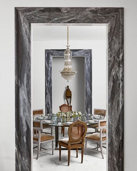 The marble door casing adds an elegant touch. | Photo: @loof39; Design: @johnoetgen #interiordesign #instahome #instadecor Door Frame Interior, Marble Door Frame, Marble Doorway, Dining Room With Round Table, Marble Door, Antique Interior Design, Veranda Magazine, Frame Interior, Black Interior Doors