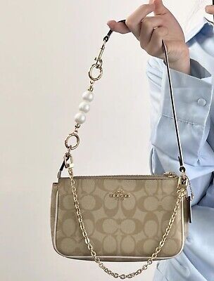 Find ideas๏ฟฝand inspiration for NWT Coach Nolita 19 In Signature Canvas c3308 + Pearl Chain + Wallet CQ145, Bags Coach Bags With Charms, Coach Nolita 19 Outfit, Cute Coach Bags, Coach Bags Aesthetic, Coach Bags Handbags, Coach Bag Outfit, Dream Purse, Coach Nolita 19, Football Wife