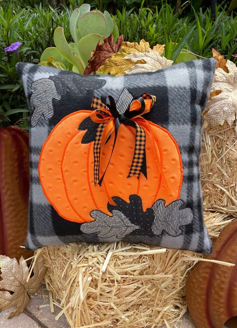 Celebrate the season with this beautiful fleece 16"x16" poly-fil stuffed pillow.   Cuddle fabric was used to create the bright, bold and dimpled pumpkin.  Various black, gray and black/white strip leaves were scattered around to add to the fall feel of this adorable pillow.  Pumpkin and leaves have appliqued and straight stitched details.  Fun ribbon was used to add that extra pop of color. Hand stuffed and hand sewn closed.  An original design. Great gift idea for that person who loves unique, Fall Embroidered Pillows, Fall Pillow Ideas, Halloween Cushions, Halloween Pillows Diy, Pillow Pumpkin, Homemade Pillows, Fall Sewing Projects, Seasonal Pillows, Fleece Pillow