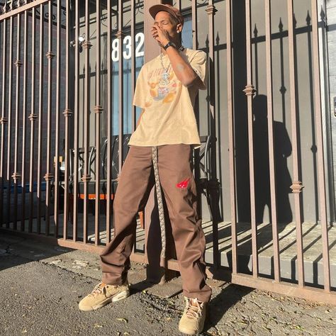 Travis Scott wearing Cacti Canvas Tan Hat, Cacti Heritage Work Brown Pants, Jordan Air Jordan 6 Retro British Khaki Sneakers. Jordan 6 Outfit, Travis Scott 6, Jordan 6 Travis Scott, Travis Scott Outfits, Travis Scott Fashion, Khakis Outfit, British Khaki, Mens Work Pants, Black Men Street Fashion