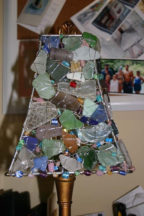 A friend of mine has been collecting sea glass for quite a while and wanted to do something with it so she asked if I could construct a lampshade out of the seaglass and some beads. I think it is turning out pretty well.....when it's dark in the room and you turn on the lamp it casts some really neat shadows on the walls. I might just have to make another one for myself:o) Sea Glass Lamp, Wire Board, Sea Glass Crafts, Broken Glass, Glass Lamp Shade, Beach Crafts, Sea Glass Art, Glass Crafts, Lamp Shades