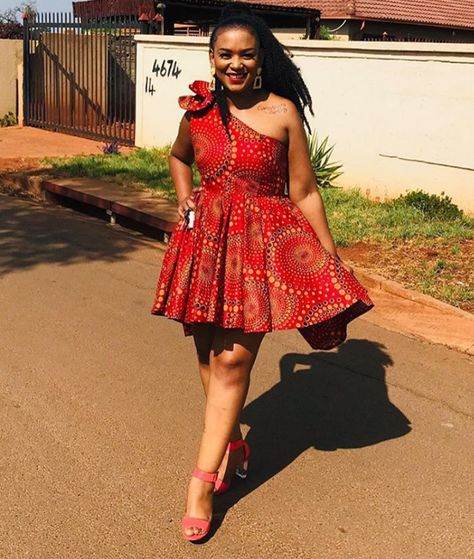 Lady In Beautiful Red One Arm Shweshwe Short Flared Dress - Clipkulture | Clipkulture One Hand Dress, Sotho Traditional Dresses, South African Traditional Dresses, African Traditional Wear, Hand Dress, Shweshwe Dresses, Traditional African Clothing, Ankara Gowns, African Dresses For Kids