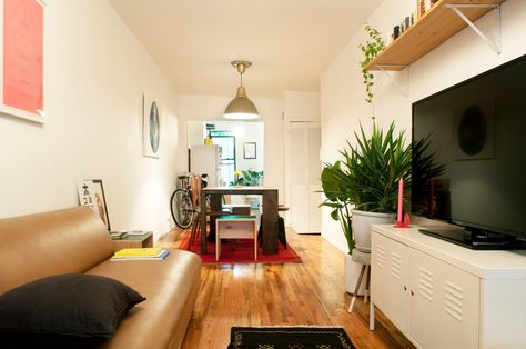 Their biggest design challenge of the apartment is the lighting. "There are no windows throughout the entire middle length of the apartment because it's a railroad, so choosing lights that looked pleasant during the day as well as at night was tough." Railroad Apartment, Apartment Goals, Cheap Apartment, Small Apartment Design, Apartment Bedroom Decor, Apartment Layout, Small Apartment Decorating, Design Challenge, Nyc Apartment