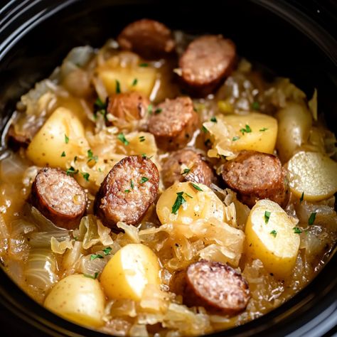 Enjoy the comforting and hearty flavors of Eastern Europe with this Easy Crockpot Polish Sausage Sauerkraut and Potatoes dish. Perfect for busy weeknights or a cozy family dinner, this recipe Sausage Potatoes And Sauerkraut, Polish Sausage Recipes Crockpot, Crockpot Polish Sausage, Kielbasa And Sauerkraut Crockpot, Polish Sausage Sauerkraut And Potatoes, Sauerkraut And Potatoes, Sausage Crockpot Recipes, Polish Sausage Recipes, Sausage Sauerkraut