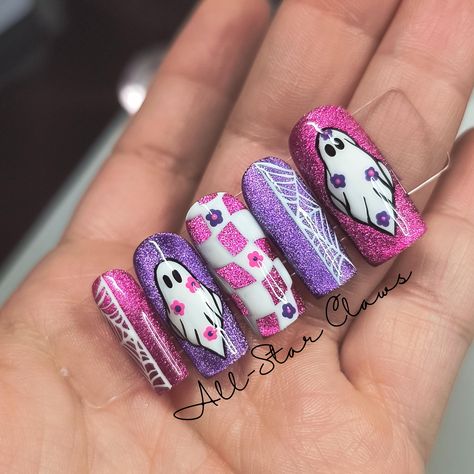 The nails alternating in pink and purple cat eye gel polish. The thumbs and ring finger have white ghosts with alternating flowers. The middle has a white waving checkered design. The pointer and pinky are split web designs. All nails have a glossy top coat finish. All nails have a builder gel layer. Available in different shapes and lengths. **Please measure your nails for the XXL length and select "XXL Custom Sizes" then send me your measurements.** Each order comes with a nail prep kit which includes nail glue, nail adhesive tabs, nail file, buffer, cuticle stick, alcohol wipes, and instructions. Please don't hesitate to ask me any questions. Cute Purple Halloween Nails, Halloween Nails Colorful, Pink And Purple Halloween Nails, Purple Jelly Nails Acrylic, Bright Halloween Nails, Halloween Birthday Nails, Purple Halloween Nail Designs, Pink Spooky Nails, Girly Halloween Nails