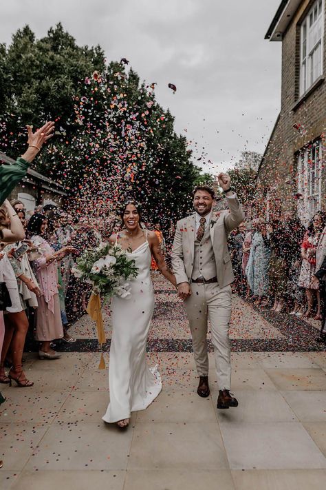 Colourful confetti photograph with bride in a satin wedding dress and groom in a beige three piece suit Satin Slip Wedding Dress, Confetti Wedding Photo, Flower Confetti Wedding, Confetti Wedding Exit, Back Garden Wedding, Slip Wedding Dress, Epic Love, Confetti Photos, Flower Confetti