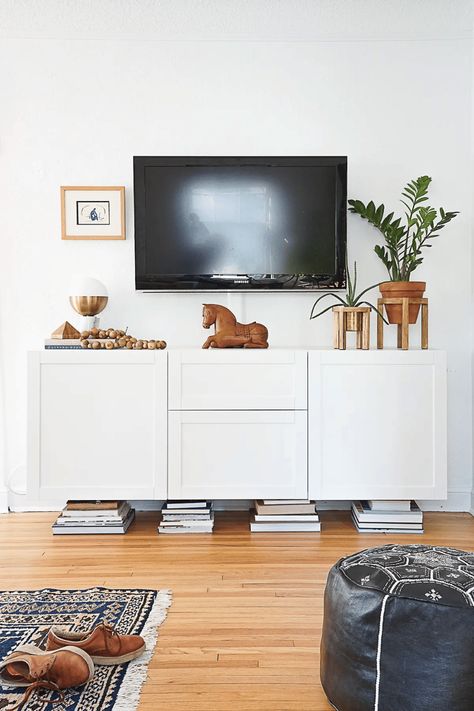 Ready to jazz up your living room? Learn how to decorate a TV console with 10 simple and stylish decor ideas that will transform your TV stand into a stunning focal point. From adding chic accessories to incorporating plants and games, these clever tips will say goodbye to that boring old look. Perfect for creating a cozy ambiance, enhancing your movie nights, and impressing guests! Elevate your space with these easy decor tweaks and let your personality shine in every detail! How To Style A Tv Console, Decorate A Tv Console, Under Tv Console Decor, Under Tv Console, Tv Console Decor, Tv Stand Decor Ideas, Television Console, Console Decor, Under Tv