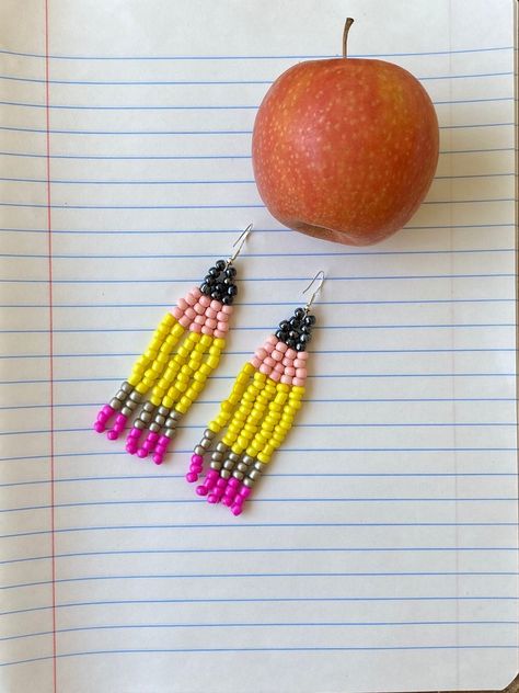 These earrings are the perfect fit for any teacher's outfit! This pair varies slightly from the other Pencil Beaded Earrings due to larger bead size & longer length. (approx 3 inches) All earrings are handmade and therefore each pair is slightly different and unique.  Custom color request? Message me! Beaded Pencil Earrings, Teacher Beaded Earrings, How To Beaded Earrings, Diy Seed Bead Jewelry, Seed Bead Jewelry Tutorials, Earring Inspired, Pencil Earrings, Seed Bead Projects, Native American Beadwork Patterns