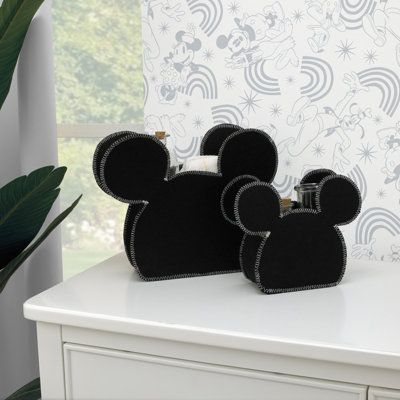 Keep your nursery organized with the Disney mickey mouse-shaped 2-piece felt storage caddy. This adorable set is featured in solid black felt with contrasting topstitched trim, in the classic mickey mouse shape. Includes one large caddy that measures 16.50" x 13" x 4" and one small that measures 10" x 8" x 3.5". Perfect for a changing area to hold your essentials or bookshelf filled with toys or as an accent atop a dresser. Add a touch of Disney magic to your nursery. Functional and cute! | Disn Mickey Mouse Nursery, Mickey Mouse Room, Disney House Ideas, Mickey Mouse Bedroom, Felt Storage, Diaper Storage, Baby Mickey Mouse, Classic Mickey Mouse, Disney Rooms