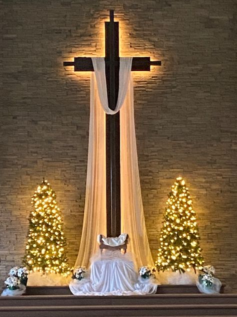 Draping the cross with sheer organza and then the manger nested in tulle - simple white Church Christmas Decorations Sanctuary, Easter Altar Decorations, Church Christmas Decor, Christmas Stage Decorations, Advent Church Decorations, Christmas Stage Design, Christian Christmas Decorations, Church Banners Designs, Advent Decorations