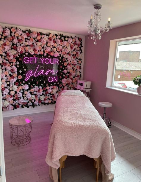 Beauty room with pink flower wall and  pink neon sign with words 'get your glam on'. Lash Room Flower Wall, Flower Wall Nail Salon, Beauty Room Inspo Interior Design, Lash Room With Desk, Beauty Room Background, Pink And Gold Beauty Room, Flower Wall Beauty Room, Flower Wall Beauty Salon, Pink Boho Spa Room