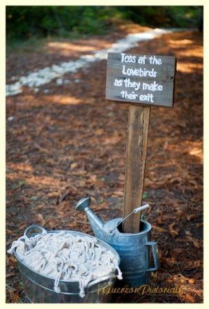 A path of white rose petals leads guests to the woods to the wedding ceremony site. On the way, they are invited to take a personalized bag of bird seed. A sign instructs them to toss the seed at the lovebirds as they make their exit. Photo courtesy of Jorge Guerzon, jGuerzonpictorials.com. Decor available to rent from Seasonal Celebrations. http://www.seasonalcelebrations.com Bird Seed Wedding Toss, Petal Toss Wedding Exit, Bird Seed Wedding Exit, Wedding Exit Petal Toss, Flower Petal Wedding Send Off, 21st Night Of September, Outdoorsy Wedding, Wedding Toss, Wedding Send Off