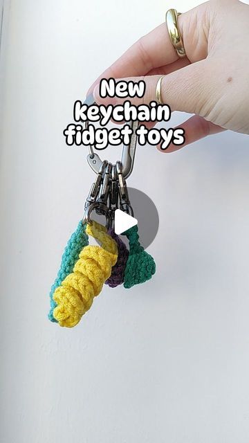 Loui Mitchell on Instagram: "🔑✨KEYCHAIN FIDGETS✨🔑

I've been making the Pushit keychain fidget for a while now, but I've been requested to make a variety of keychain fidgets, so here we are!

-Pushit (marble inside to push up and down)
-Twirlit (twisted yarn fun to stretch and twirl)
-Popit (similar to a mini dimple)
-Squishit (like a stress ball, mine is filled with popcorn kernels!) 

TESTER CALL OUT NOW, PATTERNS AVAILABLE SOON! 😅

#crochet #fidgettoy #marblepusher #pushit #twirlit #popit #minidimple #squishit #stressball #keychain" Fidget Keychain Diy, Diy Fidget Keychain, Crochet Marble Fidget, Fidgets Diy, Crochet Fidget, Popcorn Kernels, Crochet Keychain, Diy Keychain, Fidget Toys