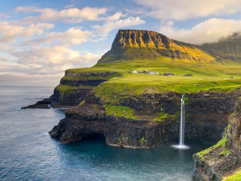 Pinterest-worthy waterfalls. Scan some Pinterest travel boards or do a quick "Faroe Islands" image search, and chances are you'll see more photos of Mulafossur Waterfall than any other site on the archipelago. The waterfall is like something from a fantasy novel, falling over the rocky cliffs of Vagar Island to the ocean below, with the the green hills of Gásadalur village as a backdrop. Faroe Islands Travel, Foggy Weather, Best Honeymoon Destinations, Best Honeymoon, Remote Island, Conde Nast Traveler, Faroe Islands, Island Travel, Beautiful Places In The World