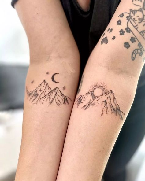 Mountain tattoos capture nature's majesty through rugged body art. These scenic designs feature peaks, ranges, and alpine landscapes. Popular mountain tattoo ideas include geometric outlines, detailed landscapes, and minimalist silhouettes. Mountain ink styles range from realistic depictions to abstract interpretations. Tattoos with mountains symbolize strength, adventure, and personal growth, often incorporating elements like trees, wildlife, or starry skies. Adventure Buddy Tattoos, Matching Mountain Tattoos For Best Friends, Matching Tattoos For Men And Women, Mountain Tattoo For Couples, Ain't No Mountain High Enough Tattoo, Girly Mountain Tattoo, Matching Nature Tattoos Couples, Mountain Hand Tattoo, Best Friend Nature Tattoos