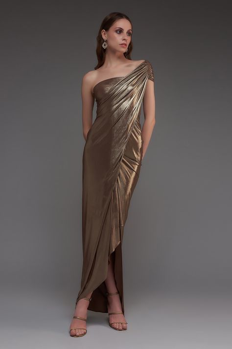 Buy Brown Stretch Knit Foil Solid Metallic One Shoulder Draped Gown For Women by Cham Cham Online at Aza Fashions. Metallic Evening Gown, Bronze Evening Dress, Drape Dresses Western, Molten Metals Bridesmaids, Bronze Wedding Dress, Metallic Wedding Dress, Bronze Gown, Drape Dresses, Metallic Bridesmaid Dresses