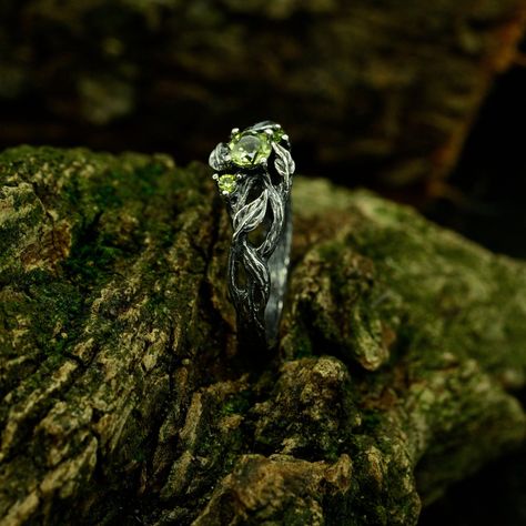 Handcrafted from sterling silver wedding band embodies the essence of nature-inspired beauty. With intricate details of a delicate tree branch and leaf, this unique forest wedding ring is designed for both men and women. The vintage style and handmade craftsmanship make it an unique jewelry, perfect for adding a touch of fantasy to any occasion. Characteristics: Metal - Recycled solid sterling silver  Stone - Cubic Zirconia Finish - Oxidized. View all silver nature wedding rings: https://www.etsy.com/shop/TinyShinyJewel?ref=seller-platform-mcnav&section_id=43427007 Care instructions: To care for the ring, avoid contact with water and chemicals such as perfumes and lotions. When the ring is not in use, store it in a dry, cool place to prevent tarnishing. Additional information:  ✦ All rings Forest Rings Engagement, Engagement Rings Forest, Nature Themed Engagement Rings, Forest Engagement Ring, Unique Forest Wedding, Forest Wedding Ring, Nature Rings, Nature Wedding Band, Nature Wedding Ring