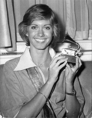 3-1 in 1975: At tonight's Grammy Awards, the big winners are: Olivia Newton-John -shown here in the photo - (Record of the Year for "I Honestly Love You," Female Pop Vocal), Paul McCartney (Male Pop Vocal for "Band On The Run"), Stevie Wonder (Album of the Year for Fulfillingness' First Finale), and Barbra Streisand's "The Way We Were" for Song of the Year. Olivia Newton John Young, Olivia Newton Jones, John Barry, Olivia Newton, Farrah Fawcett, Olivia Newton John, John Travolta, Iconic Women, Female Singers