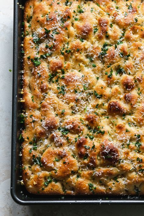 This Garlic Bread Focaccia is fluffy on the inside, crunchy and deeply golden on the edges, and doused in melted garlic butter. It's undoubtedly on of the best things to ever come out of my kitchen. It's the perfect vehicle for sandwiches, served with soup, dipped in more garlic butter (!!), or just simply eaten on its own. Salty, garlicky, buttery, fluffy, crunchy, golden brown perfection! Focaccia Bread Sticks, Garlic Herb Focaccia Bread, Focaccia And Dip, Cheesy Garlic Sourdough Foccacia Bread, Foccacia Bread Garlic Butter, Foccacia Bread Sheet Pan, Dips For Focaccia, Garlic Butter Foccacia Bread Recipes, Traditional Focaccia Bread