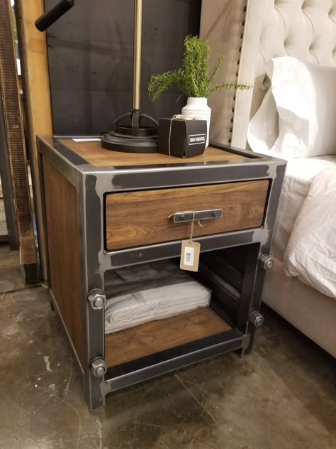 Introducing our industrial nightstand, handmade with care and attention to detail. This unique piece combines the beauty of reclaimed wood and the durability of galvanized steel to create a functional and stylish addition to your bedroom. The nightstand features a sturdy welded black steel frame, which provides exceptional durability and strength. The two spacious drawers are constructed with high-quality galvanized steel, which offers long-lasting resistance to rust and corrosion. Plus, with he Steel Nightstand, Diy Projects Wood, Industrial Bedside Tables, Wood Working Ideas, Metal Tables, Industrial Style Bedroom, Metal Nightstand, Welded Furniture, Staining Cabinets