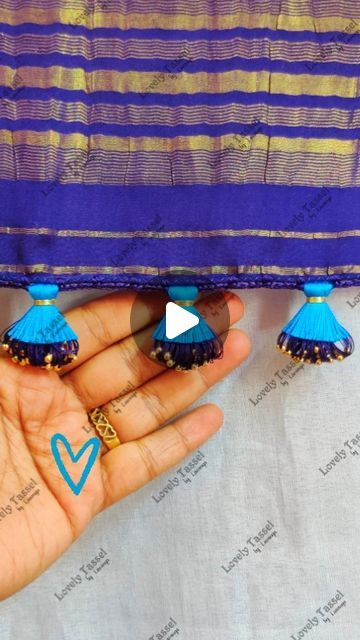 Lovely Tassel Work by Lavanya on Instagram: "Designer Double Step Tassel Work💙Notes👇
•8 Strands of silk thread for Crochet base
•Crochet Needle no. 9
•4 chain base
•6 strands of silk thread knotted at end(approx 4.5 feet length)
•wrapped 22 times using one inch thick board by inserting one small bead each time in 4 chain gap
•knotted using 2 strands of cotton thread
•160 strands of silk thread glued at tip and tied second tassel, using 2 strands of zari thread
• trimmed to half length both the sides separately
•Gap between each tassel 2 inches
•Happy Tasseling 😊 Thank you 🙏
.
.
.
#lovelytassel #saree #sareetassel 
#sareekuchulu #sareekuchu #kuchulu 
#tassels #kuchu #weddingsarees 
#bridalsarees #insta 
#indianwomenfashion #threadwork 
#diy #sareepalluhangings #sareetassels 
#handcrafte Kuchu Designs Saree, Tassels On Saree Pallu, Simple Tassels For Saree Pallu, Fabric Tassels For Saree Pallu, Saree End Tassels, Saree Kongu Kuchulu, Saree Kuchulu, Crochet Base, Saree Kuchu New Designs