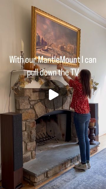 Andrea on Instagram: "There was one spot to put a tv in our living room and that was above the fireplace. The fireplace is tall and deep so it made the tv too high to view comfortably. With our MantleMount at @bestbuy we are able to pull the tv down to a comfortable viewing height, it clears my seasonal decor and is easy to put back up. Since we have gas logs, it’s to turn the fire off when we want to watch tv or we just put it back up. However, the fireplace installer also said we could probably watch tv (just not the whole day) with a fire going since it’s a full two feet from the fire and the mantle is 12” deep so it blocks most of the heat. Having the ability to pull the tv down and turn it to whichever angle we want is perfect! It allows for a functional and beautiful install of our Fireplace Tv Opposite Walls, What To Do With Tv Hole Above Fireplace, Projector Above Fireplace, Pull Down Tv Over Fireplace, Framed Tv Above Fireplace, Big Tv Above Fireplace, Living Room Gas Fireplace With Tv, Tv Sitting On Mantle, Tvs Above Fireplaces