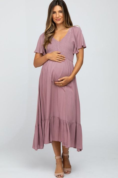 A solid maternity midi dress. Features smocked bust with v-neckline, short bell sleeves, and ruffle hemline. Skirt is lined. Short Bell Sleeves, Shower Outfits, Mother Of The Bride Gown, Maternity Midi Dress, Trendy Maternity, Baby Shower Dresses, Maxi Gown Dress, Mauve Dress, Shower Dresses