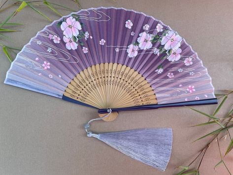 Handheld Folding Hand Fan with a Pouch and Optional Fan Gift Box  High-End Style Folding Hand fans Designs are fashionable and  High-Quality are nifty little products which are ideal for day-to-day personal use, presenting as gifts, using as decorations, wedding or party favours, or cosplay accessories. It comes with a beautifully handcrafted gift box just made for these skillfully crafted fans and a super soft fabric pouch, which adds more luxury. The gift box is wrapped in a cellophane bag. Th Fabric Hand Fan, Folding Fabric, Red Spider Lily, Colorful Gift Wrapping, Folding Fans, Flowers Artwork, Purple Accessories, Folding Hand Fan, Japanese Fan