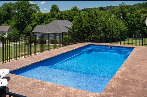 A simple budget-friendly inground fiberglass pool installation with great features including a tanning ledge, stairs, and seating in the deep end. Shallow Inground Pool, Inground Pool Ideas Simple, Pool Splash Pad, In Ground Pool With Tanning Ledge, Inground Pool Ideas With Tanning Ledge, Simple In Ground Pool Ideas, Inground Pool Tanning Ledge, Simple Pool Ideas Inground, Fiberglass Pools With Tanning Ledge