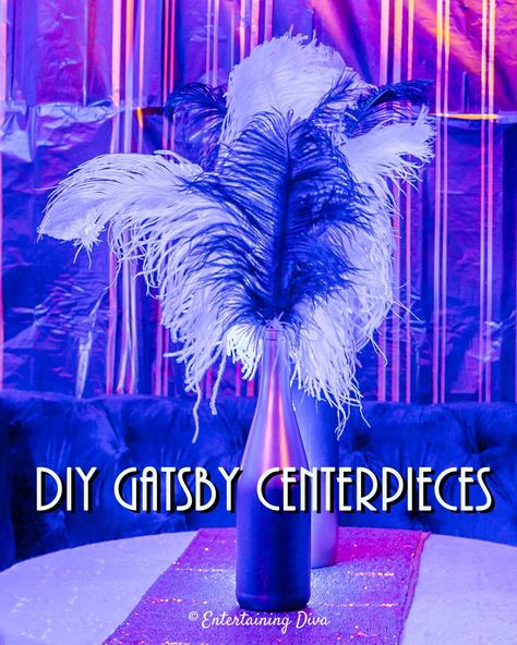 Made with ostrich feathers, wine bottles, faux flowers, champagne glasses, martini glasses and candles, these DIY Gatsby party centerpieces are easy to make, and look beautiful. A great way to add some glam to my 1920s event decor. #entertainingdiva #roaring20s #gatsbywedding #centerpieces #partydecor #diypartydecor Diy Gatsby Party, Great Gatsby Centerpieces, Feather Centerpieces Diy, 20s Party Decor, Gatsby Centerpieces, Feather Centerpiece Wedding, 20s Party Decorations, Ostrich Feather Centerpieces, Roaring 20s Wedding