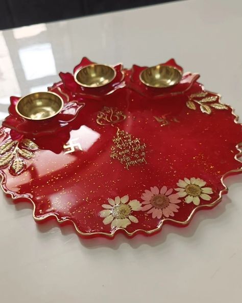 Resin Pooja thali ✨ Tilak thali or Pooja thali for gifting purpose on diwali, Rakshabandhan or any auspicious occasion. Dm to place order ✨ #resinplatter #resinpoojathali #resintilakthali #resinrolichawalplatter #resintilakplatter #resinpoojaplatter #resingiftideas #handmadethali #handmadeplatter #poojaplatter How did you like the color. ? Resin Pooja Thali, Karwachauth Thali, Engagement Tray, Pooja Thali, Resin Art, Diwali, Tray, Frame, Gifts