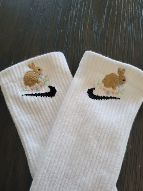 Rabbit is custom embroidered with floral accents above the branded symbol on white crew socks. MEDIUM SIZE (6-10 WOMEN, 6-8 MEN) | LARGE (10-13 WOMEN, 8-12 MEN) If you want a looser fit, size up to the large. They are only embroidered on the outside. 1 on each sock. If you want it on both sides of 1 sock reach out and will result in additional charge. Easter Socks, Bunny Socks, White Crew Socks, Crocs Fashion, Embroidered Socks, Trendy Socks, Cute Nike Outfits, Cute Nikes, Cute Socks