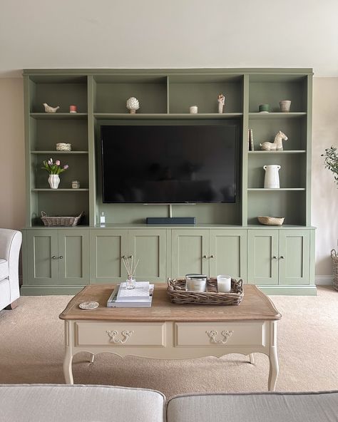 Happy Sunday! This is my current view as I sit with a cup of tea, a good book and a very sleepy puppy ☺️☕️ I get lots of questions about the media unit in the living room - we had the unit built bespoke by a local carpenter and then painted it in F&B Treron (colour matched with Brewer’s paint) 💚 The cupboard handles are from @ah_brass and our tv size is 65’ I’m so glad I went with the bold colour! It’s the focal point of the room and I love it 🥰 . . #mediaunit #mediawall #mediawalldesi... Coloured Cabinets Living Room, Painted Built In Tv Cabinet, Fitted Cabinets Living Room, Media Units Living Room, Built In Living Room Cabinets, Living Room Built Ins With Tv, Media Unit Living Room, Built In Cupboards Living Room, Living Room Built In Cabinets