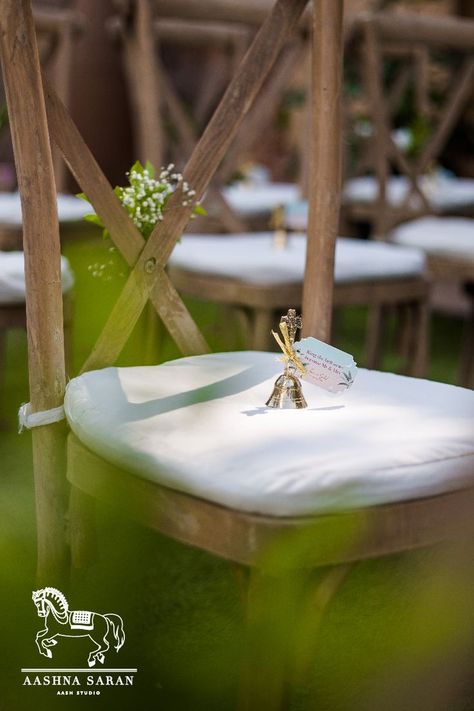 The wooden seat backs had Ivy vines intertwined around them, to add a sustainable touch and the chairs had bells for the guests to ring them as they turn Mr. & Mrs. . . . #AashStudio #AashnaSinghSaran #WeddingSeatingDecor #DestinationWedding #MandapDesign #Bouquets #OutdoorWeddings #DecorIdeas #WeddingSeating #DecorIdeas #WeddingInspo #WeddingDecor #WeddingDecorIdeas #IndianWeddings #WeddingDesign #WeddingBells #WeddingChairDecor #ChairBacks #ChairDecor #WeddingChairs #FloralChair Winter Garden Wedding, Mandap Design, Floral Chair, Wedding Chair Decorations, Guest Chair, Wedding Chairs, Chair Decorations, Indian Wedding Decorations, Wedding Seating