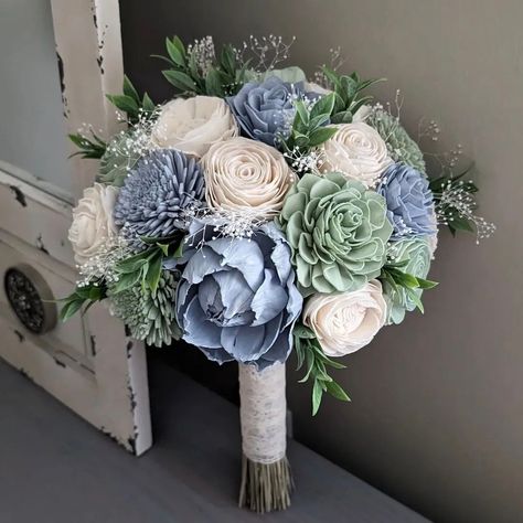 Please Read Entire Description Before Purchase Bouquet with sola wood flowers in sage, dusty blue, and ivory, with baby's breath and faux greenery. Flower styles can and will vary based on current inventory levels and to keep orders unique, so they are not exact duplicates. Please include your choice of stem wrap and color (color of ribbon, white or ivory lace, or twine) in the notes section.  Size pictured is a medium (approximately 8" in diameter). Bouquets listed in the Etsy shop are not elig Sage And Periwinkle, Dusty Blue And Sage Green Bridal Bouquet, Blue And Green Bouquet Wedding, Sage Green And Navy Blue Wedding, Dusty Blue And Sage Wedding, Sage Green And Blue Wedding, Sage Green And Dusty Blue Wedding, Dusty Blue And Sage Green Wedding, Blue Fall Wedding