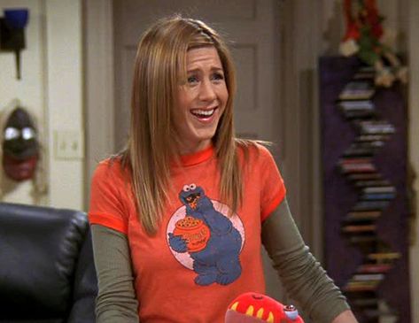 1990s: T-Shirts Over Long-Sleeve Shirts- HarpersBAZAAR.com Rachel Green Tshirt, Tshirt Over Long Sleeve Outfit, Shirt Over Long Sleeve, Rachel Outfits, Cookie Monster T Shirt, 1990s Fashion Trends, Long Sleeve Shirt Outfits, Rachel Green Friends, Rachel Green Style