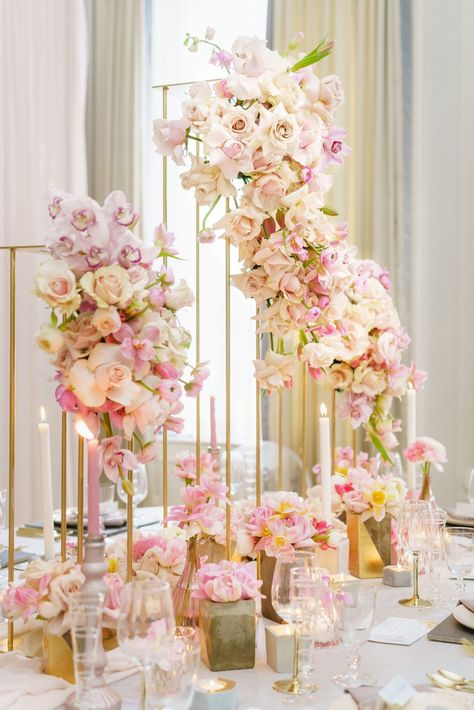 A luxurious wedding table with gold pillar floral centrepieces. These sculpted floral centrepieces include pink and white flowers by @FlowerFactoryVancouver. This wedding table designed by a Vancouver wedding planner included pink candlesticks and concrete floral vases. Save this photo if you are planning a blush pink and gold wedding. Decor: @flowerzvancouver1 Pink Cake Stand, Floral Centrepieces, Tall Wedding Centerpieces, Gold Wedding Decorations, Wedding Floral Centerpieces, Blush Bridal, Wedding Set Up, Crosses Decor, Event Planning Design