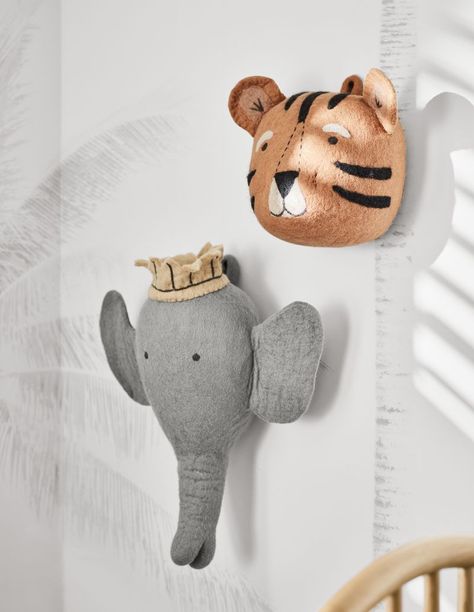 A friendly face makes this tiger a rawr-y cute finishing touch in the nursery, kid's room or playroom. Carefully handmade of felted wool, this sweet, striped pal keeps a close eye on your little cub with fuzzy round ears and delicate embroidered features.   • Handmade  • 100% felted wool with embroidered details  • Due to its handmade nature, each item will vary slightly  • Spot clean only  • Made in Nepal Felt Tiger Animal Head Wall Decor Baby Animal Nursery Theme, Twin Nursery Decor, Nursery Animal Heads, Felt Tiger, Safari Wall Decor, Magical Nursery, Felt Elephant, Animal Head Wall Decor, Head Wall Decor