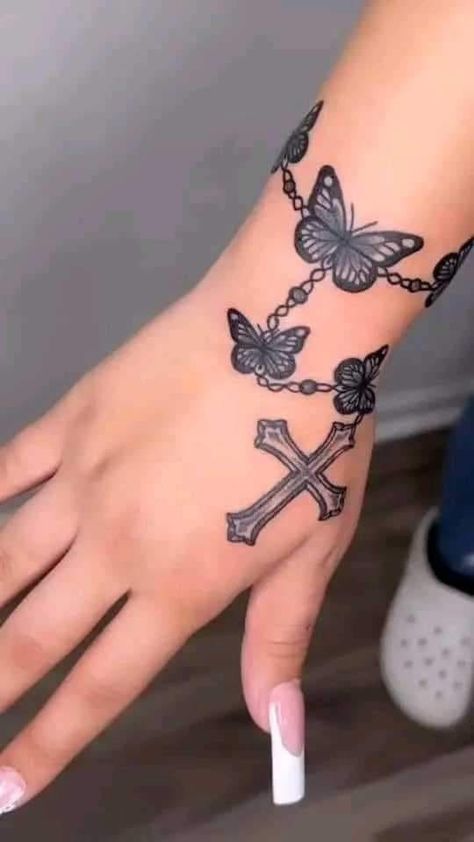 Cross Butterfly Tattoo For Women, Women Thumb Tattoos, Hand Tattoos Rosary, Sleeve Tattoos Butterflies, Womens Hand Tattoos Simple, Jesus Finger Tattoo, Faith Cross Tattoos For Women, Butterfly Rosary Tattoo, Rosary Hand Tattoos For Women