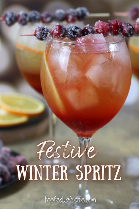 With orange liqueur, cranberry simple syrup, Prosecco and sparkling water, this Winter Spritz is a festive drink for Christmas, New Years or winter parties. #WinterSpritz #WinterSpritzCocktail #ChristmasSpritzer #ChristmasSpritzerDrink #ChristmasSpritzCocktail Winter Spritzer Drinks, Christmas Spritzer Drink, Winter Spritz, New Years Drink, Spritzer Cocktails, Spritzer Drink, Christmas Spritz, Spritz Cocktails, Cranberry Simple Syrup