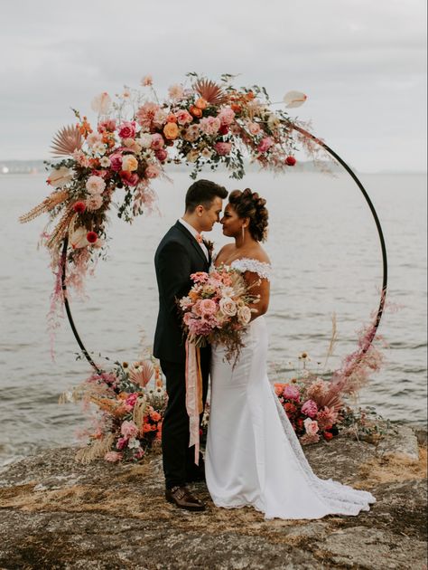 Circle arch, elopement by the ocean, flower arch, elopement inspiration, bright florals, floral circle arch, vancouver elopement, vancouver wedding ceremony, colourful floral arch #floralarch #elopementphotographer #elopementideas Wedding Arch Round, Circle Wedding Arch, Party Backdrop Stand, Boho Wedding Arch, Beach Wedding Arch, Circle Arch, Wedding Arbor, Wedding Hoop, Wedding Ceremony Arch