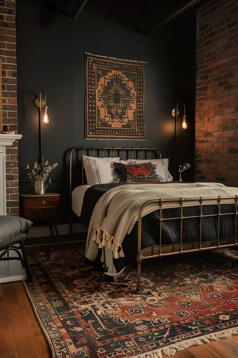 Modern bedroom with a dark accent wall behind the bed, industrial lamps, vintage rug, metal bed frame, and brick elements for a cozy, eclectic look. All Black Bedding Bedroom Ideas, Black Attic Bedroom, Accent Black Wall Bedroom, Black Wall Bedroom Aesthetic, Dark Color Drenched Bedroom, Black Brick Accent Wall, Dark And Moody Bedroom Ideas, Eclectic Moody Bedroom, Basement Bedroom No Windows