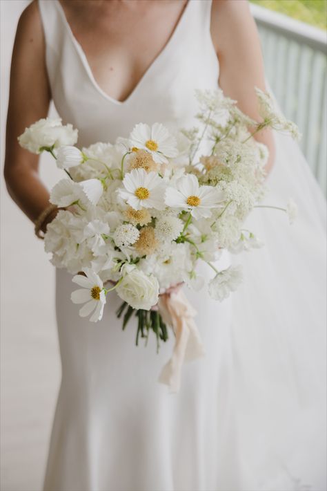 A coastal summer bridal bouquet designed with cosmos, lisianthus, scabiosa, and Queen Anne's lace. Cassie Castellaw Photography Castiglione Events White Lace Flower, White Summer Bridal Bouquet, White Cosmos Bridal Bouquet, Bridal Bouquet Yellow And White, Queen Anne Lace Bouquet, Queen Annes Lace Bridal Bouquet, White Yellow Wedding Flowers, Bridal Bouquet Daisies, White And Yellow Flower Bouquet