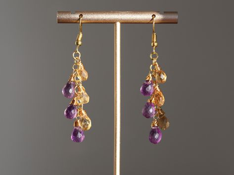 Long and elegant cluster earrings with Amethyst and Citrine gemstone briolettes creating luxurious waterfall of droplets. The wire and ear wires are in gold color. Earrings are slightly heavier due to gemstones. Total length is 6.5 cm (2.6 inch) We offer two variants of international shipping: -Standard untraceable shipping -Tracked shipping upgrade   Tracked shipping upgrade is our recommended option for the delivery. With tracking number you will be able to check online where exactly your parc Purple Waterfall, Citrine Cluster, Waterfall Chandelier, Amethyst And Citrine, Earrings Purple, Earrings Crystal, Citrine Gemstone, Cluster Earrings, Yellow Purple